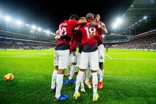 Jesse Lingard of Manchester United celebrates with teammates Marcus Rashford and Ashley Young after scoring 1-4