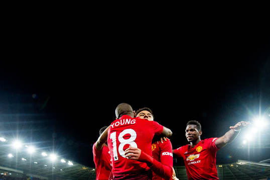 Jesse Lingard of Manchester United celebrates with teammates Ashley Young and Paul Pogba after scoring 1-4