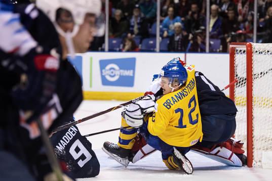 Erik Brännström of Sweden wrestle goaltender Kyle Keyser
