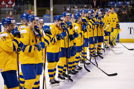 Lucas Elvenes of Sweden and his teammates look dejected