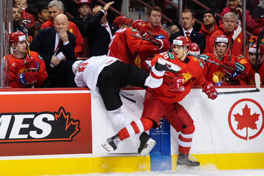 Janis Moser of Switzerland is being tackled overboard by