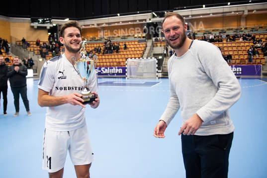 Andreas Granqvist lämnar över vinnarpokalen till Hittarps Andre Kopfinger efter finalen