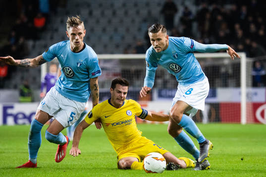 Sören Rieks and Arnor Traustason of Malmö FF compete for the ball with Callum Hudson-Odoi of Chelsea 
