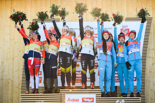 Heidi Weng, Ingvild Flugstad Østberg, Astrid Uhrenholdt Jacobsen, Therese Johaug of Norway, Ebba Andersson, Frida Karlsson, Charlotte Kalla, Stina Nilsson of Sweden, Yulia Belorukova, Anastasia Sedova, Anna Nechaevskaya and Natalia Nepryaeva of Russia celebrates at the podium after women's 4 x 5km relay