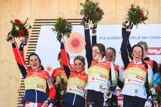 Heidi Weng, Ingvild Flugstad Østberg, Astrid Uhrenholdt Jacobsen, Therese Johaug of Norway, Ebba Andersson, Frida Karlsson, Charlotte Kalla, Stina Nilsson of Sweden celebrates at the podium after women's 4 x 5km relay