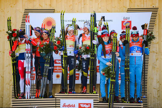 Heidi Weng, Ingvild Flugstad Østberg, Astrid Uhrenholdt Jacobsen, Therese Johaug of Norway, Ebba Andersson, Frida Karlsson, Charlotte Kalla, Stina Nilsson of Sweden, Yulia Belorukova, Anastasia Sedova, Anna Nechaevskaya and Natalia Nepryaeva of Russia celebrates at the podium after women's 4 x 5km relay