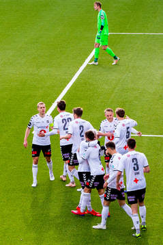 Steffen Hagen, Fredrik Lund Nordkvelle and the players of Odd celebrate the 1-1 goal while goalkeeper Eirik Holmen Johansen of Brann looks dejected