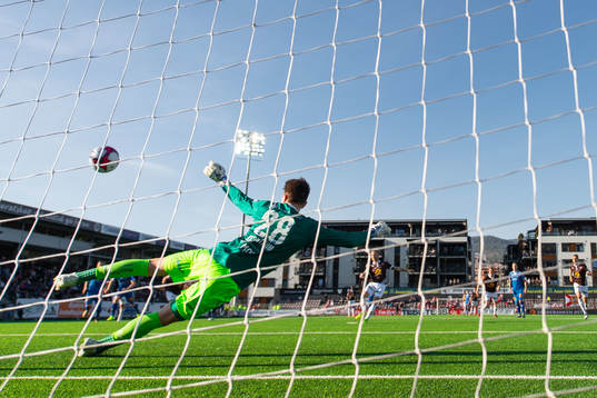 Tonny Brochmann of Mjøndalen scores 1-0 behind goalkeeper