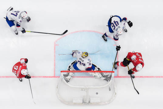 Gregory Hofmann of Switzerland scores 3-0 behind goaltender