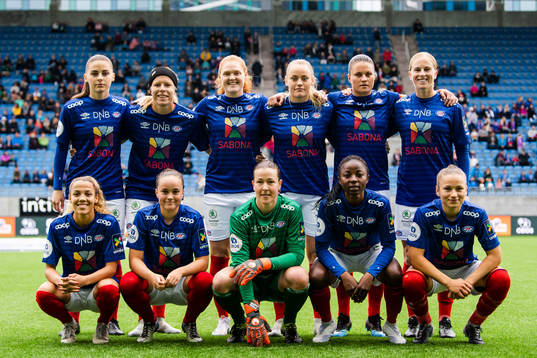 Jenna Dear (2nd row), Ingrid Katrine Buer Søndenå, Stine Pedersen, Victoria Ludvigsen, Sherida Spitse, Natasha Dowie, Celin Bizet Ildhusøy (1st row), Kine Fløtre, goalkeeper Tinja Korpela, Ajara Njoya and Svanhild Sand of Vålerenga line up for a team photo ahead of the Toppserien football match between Vålerenga and Lyn on May 18, 2019 in Oslo.
