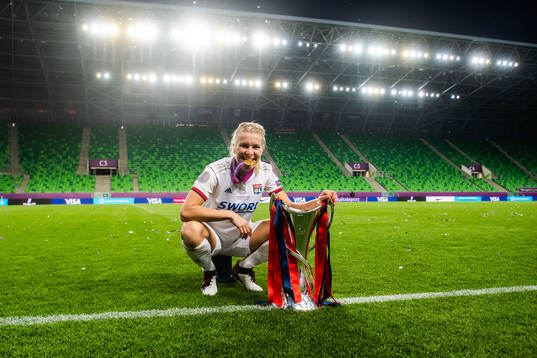 Ada Hegerberg of Lyon poses for a portrait with her gold medal and the trophy