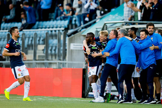 Yacouba Sylla of Strømsgodset celebrates with Stian Ringstad, Jakob Glesnes, Håkon Wibe-Lund, caretaker manager, and teammates after scoring 1-1