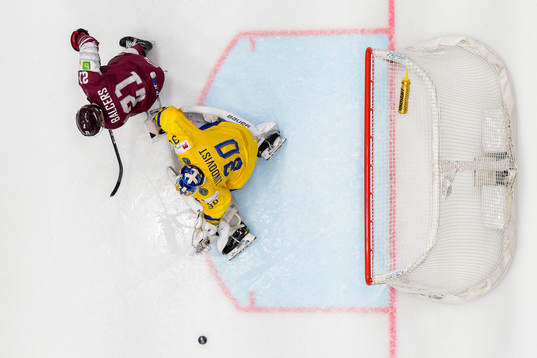 Rudolfs Balcers of Latvia and goaltender Henrik Lundqvist