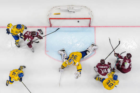 Janis Jaks of Latvia scores the 2-3 goal behind goaltender