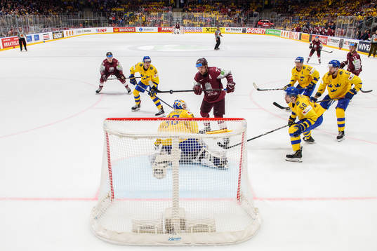 Janis Jaks of Latvia score the 4-4 goal behind goaltender