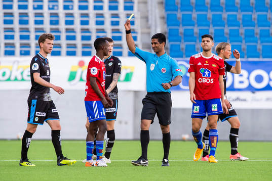 Hassan Mohamed Yousef of Skeid is shown a yellow card by