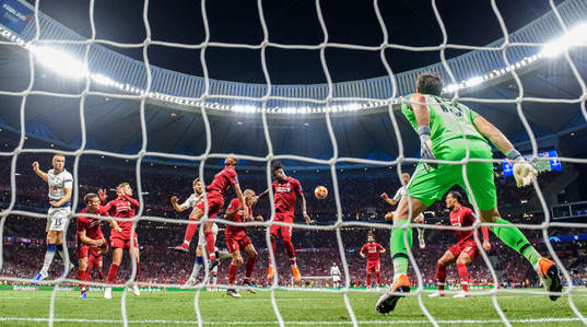 Eric Dier of Tottenham in action with Fabinho, Divock Origi