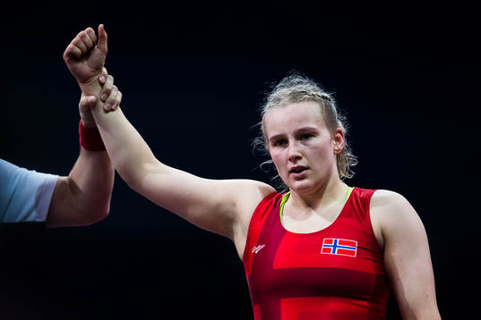 Iselin Solheim of Norway (red) celebrates as she wins over Aysegul Ozbege of Turkey (blue, not pictured) in the Women´s 76 kg Wrestling Repechage Round 1