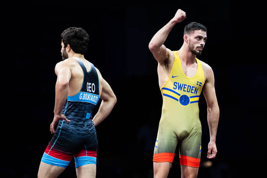 Alex Bjurberg Kessidis of Sweden (red) celebrates winning against Gela Bolkvadze of Georgia (blue) in the Men´s 77 kg Greco-Roman Wrestling 1/8 Finals