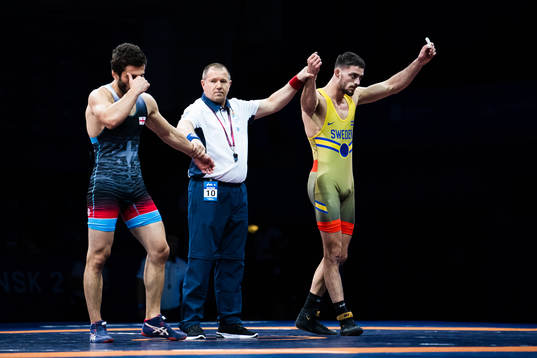 Alex Bjurberg Kessidis of Sweden (red) celebrates winning against Gela Bolkvadze of Georgia (blue) in the Men´s 77 kg Greco-Roman Wrestling 1/8 Finals