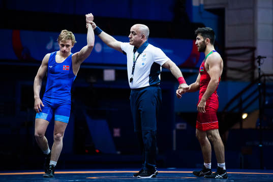 Håvard Jørgensen of Norway (blue) celebrates as he is called as winner in the match against Karim Jaforov of Azerbaijan (red, not pictured) compete in the Men´s 67 kg Greco-Roman Wrestling 1/8 Finals