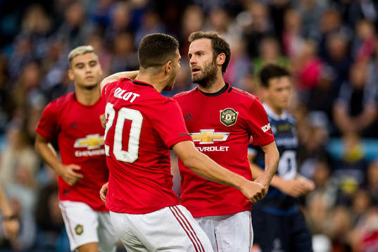 Juan Mata of Manchester United celebrates with teammates after scoring the 0-1 goal