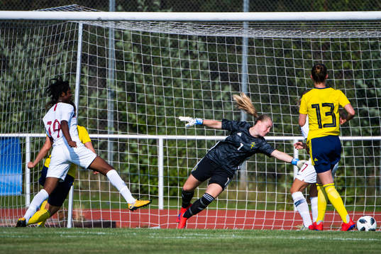 Joshualyn Revees of Norway scores 1-0 behind goalkeeper Julia Langörgen of Sweden during the women's