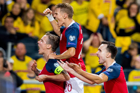 Stefan Johansen of Norway celebrates with teammates Martin Ødegaard and Ole Kristian Selnæs after scoring 0-1
