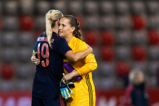 Carina Wenninger and goalkeeper Laura Benkarth of Bayern