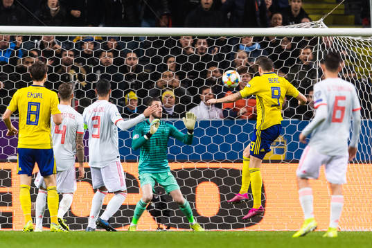Marcus Berg of Sweden scores 1-0 behind goalkeeper David de