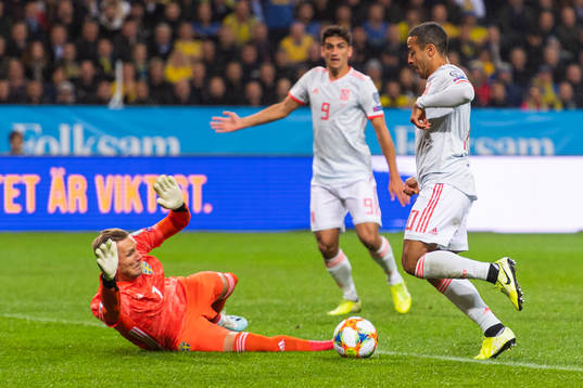 Goalkeeper Robin Olsen of Sweden saves a chance from Thiago