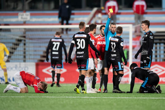 Claes Kronberg of Sandnes Ulf gets a yellow card by Marius