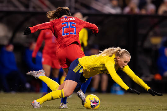 Andi Sullivan of USA trips Stina Blackstenius of Sweden