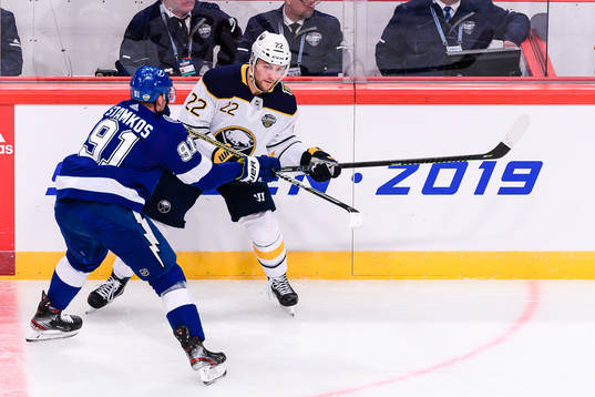 Johan Larsson of Buffalo Sabres gets hit by Steven Stamkos