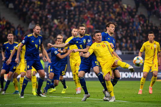 Marcus Berg and Albin Ekdal of Sweden in action against Claudiu Keseru of Romania