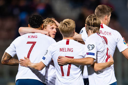 Joshua King of Norway celebrates with team mates after scoring 0-1