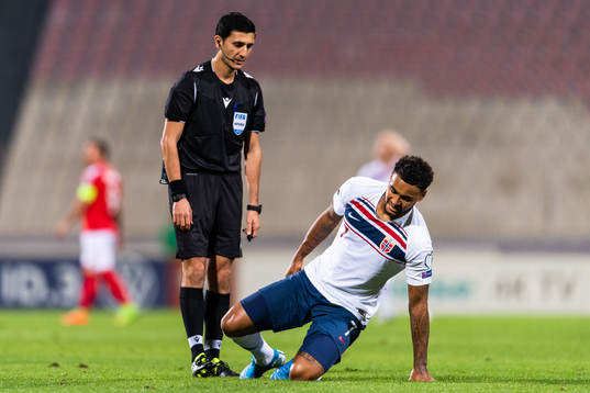 Referee Aliyar Aghayev see Joshua King of Norway sit down injured