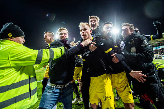 Martin Ramsland of Start celebrates with Mathias Idsøe Bringaker, Isaac Twum and teammates after scoring 4-3 during the Eliteserien playoff football match between Lillestrøm and Start on December 11, 2019 in Lillestrøm.
