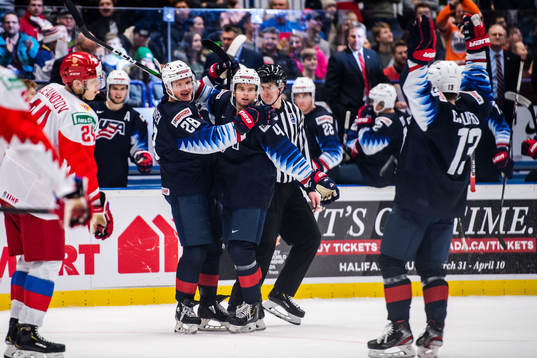 Arthur Kaliyev, Cole Caufield and Cam York of USA  celebrate