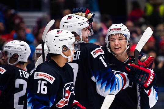 John Beecher and Trevor Zegras of USA celebrate
