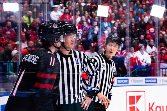 Alexis Lafreniere of Canada talks to Linesman Ludvig