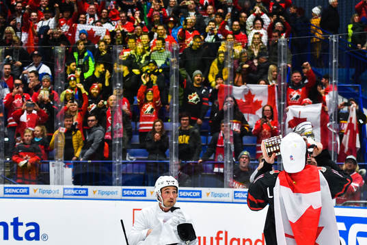 Alexis Lafreniere of Canada celebrate with the trophy and a