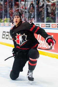 Dylan Cozens of Canada celebrates