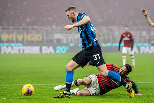 Milan Skriniar of Inter and Hakan Calhanoglu of Milan