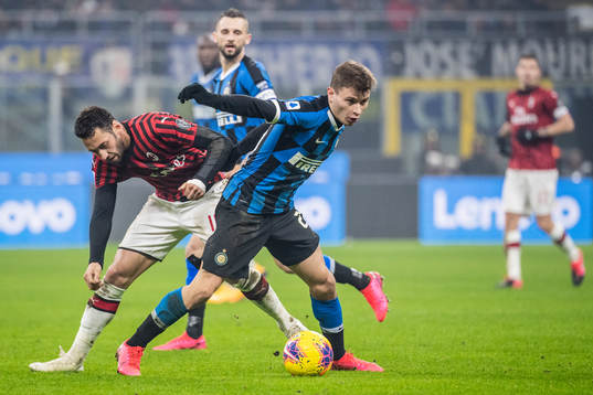 Hakan Calhanoglu of Milan and Nicolo Barella of Inter