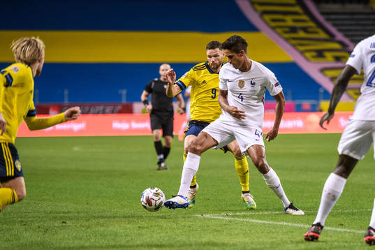 Marcus Berg of Sweden and Raphaël Varane of France