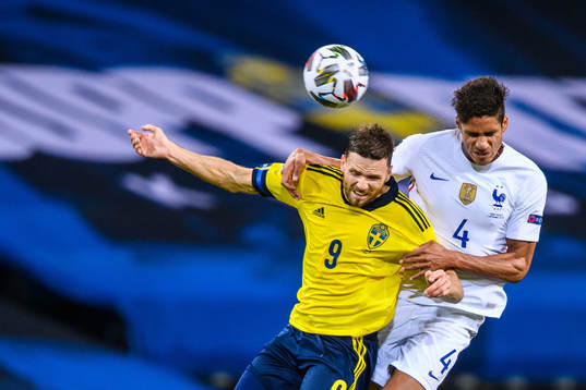 Marcus Berg of Sweden and Raphaël Varane of France