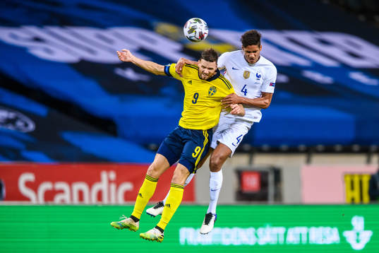 Marcus Berg of Sweden and Raphaël Varane of France