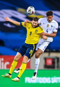Marcus Berg of Sweden and Raphaël Varane of France