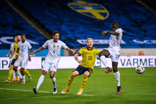 Dayot Upamecano and Raphaël Varane of France against John